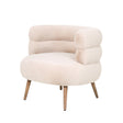 Vooraanzicht van de knusse design fauteuil in aaibare beige teddy-stof met een ronde zitting en schuingeplaatste houten pootjes.